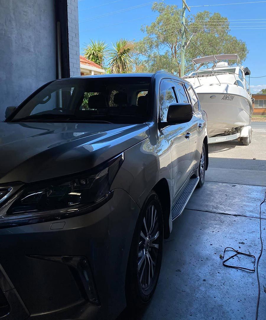 SUV with a Boat in a Trailer on Lavington Auto Electrical's Premises — Lavington Auto Electrical in Lavington, NSW