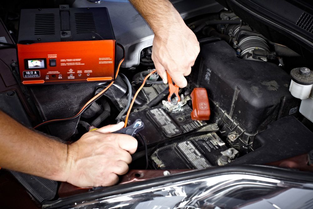Auto Mechanic Working On An Electrical Fault