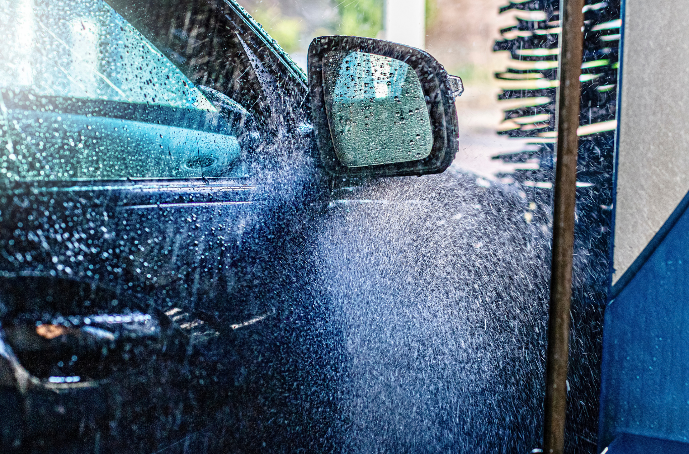 A car is being washed in a car wash.