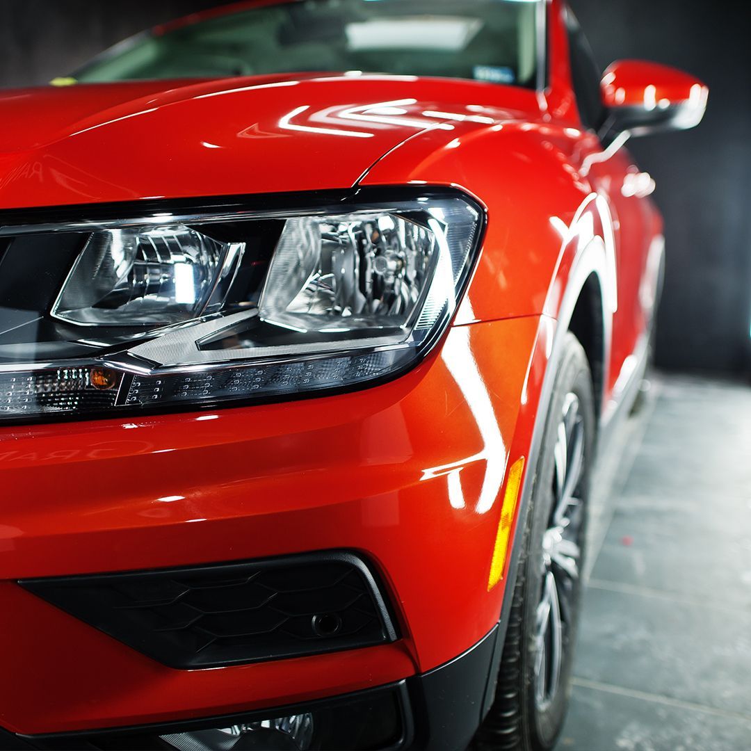 A close up of the front of a red car