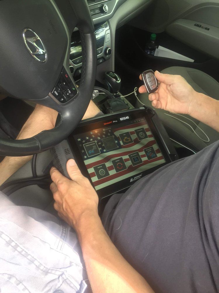 A person is sitting in a car using a tablet.