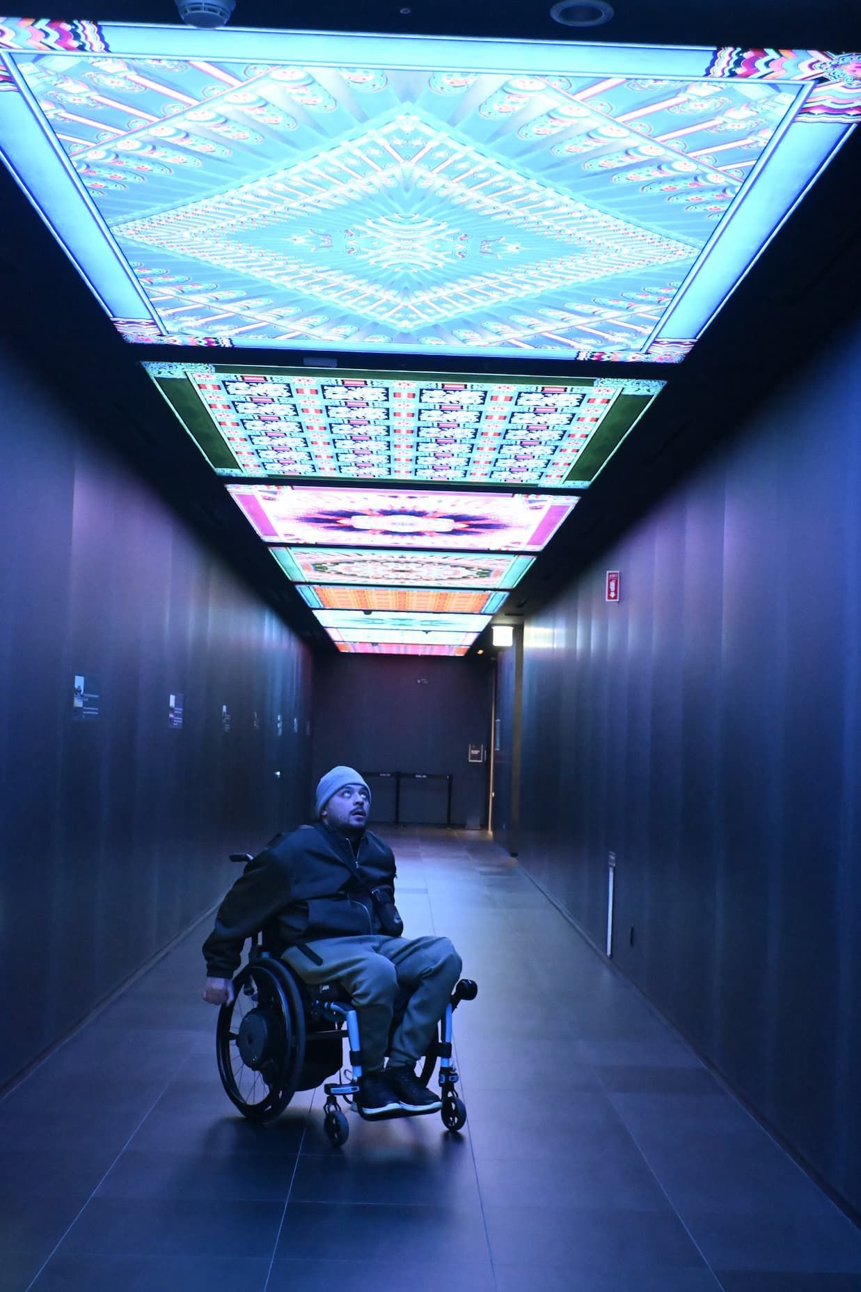 Shem exploring a famous library in South Korea independently in his Apex-C wheelchair with DuoDrive