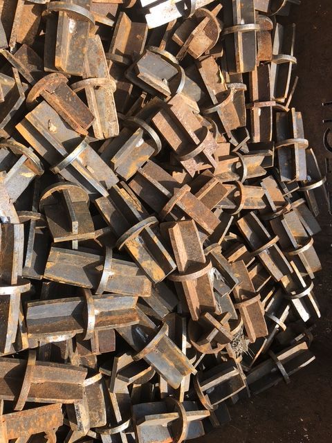 Pile of rusted, geometric metal pieces.