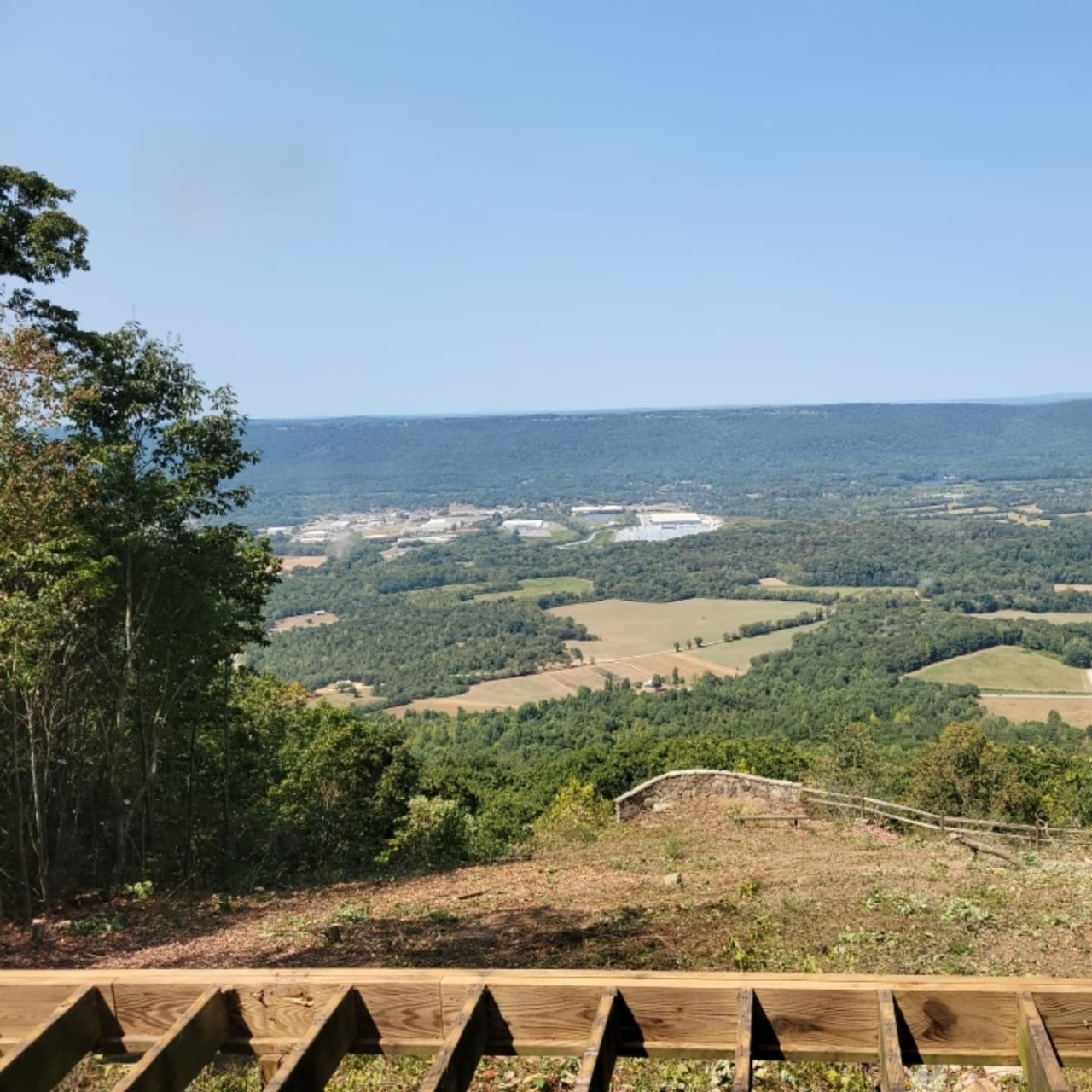 A view of a valley from a wooden deck