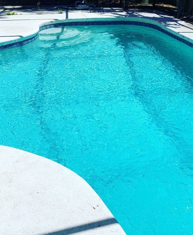 A large house with a swimming pool in front of it