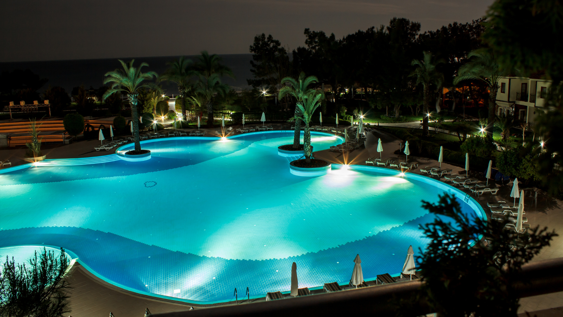 A swimming pool is being built with blue tiles.