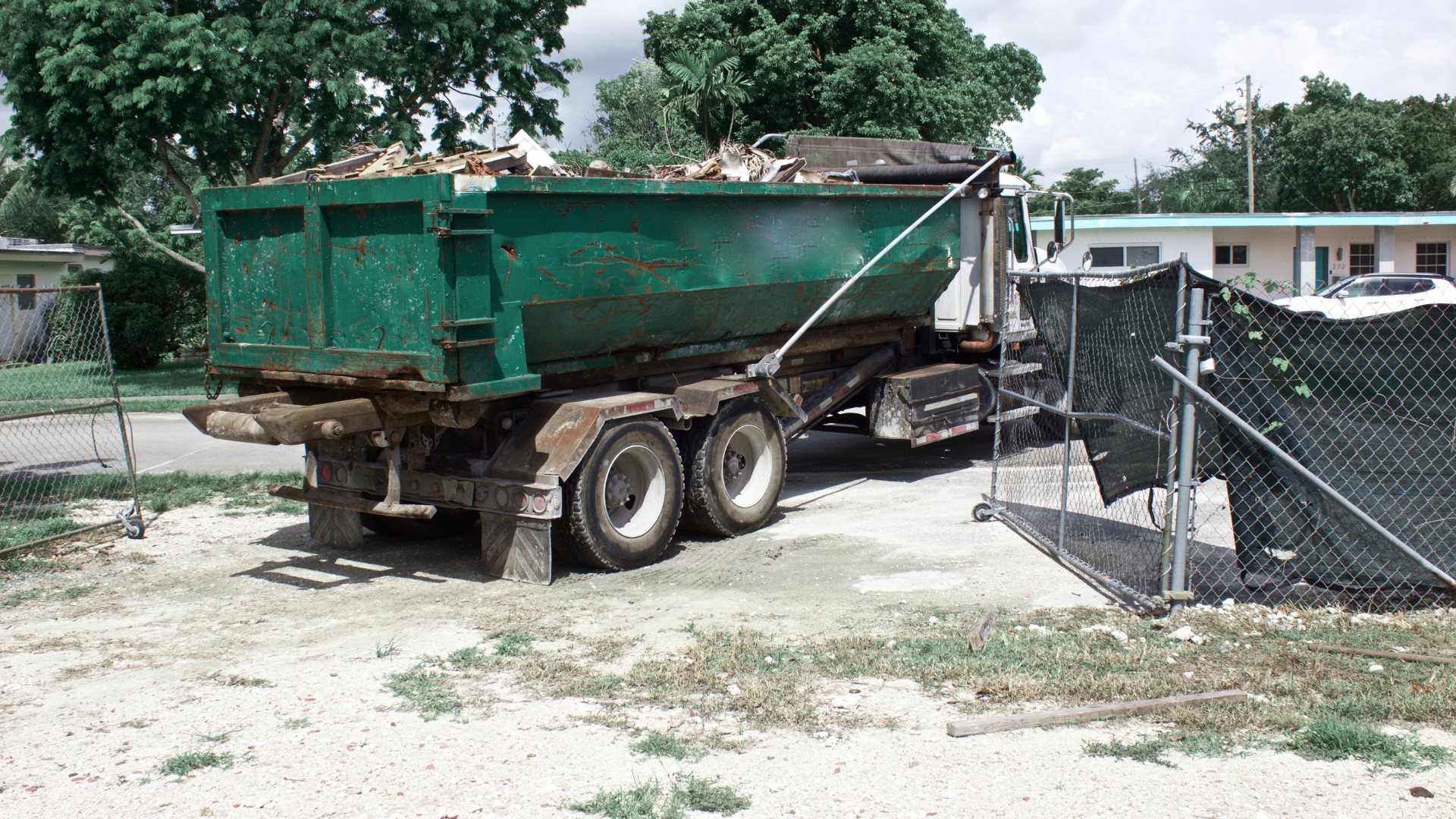 Dumpster rental placed near garage for household decluttering project