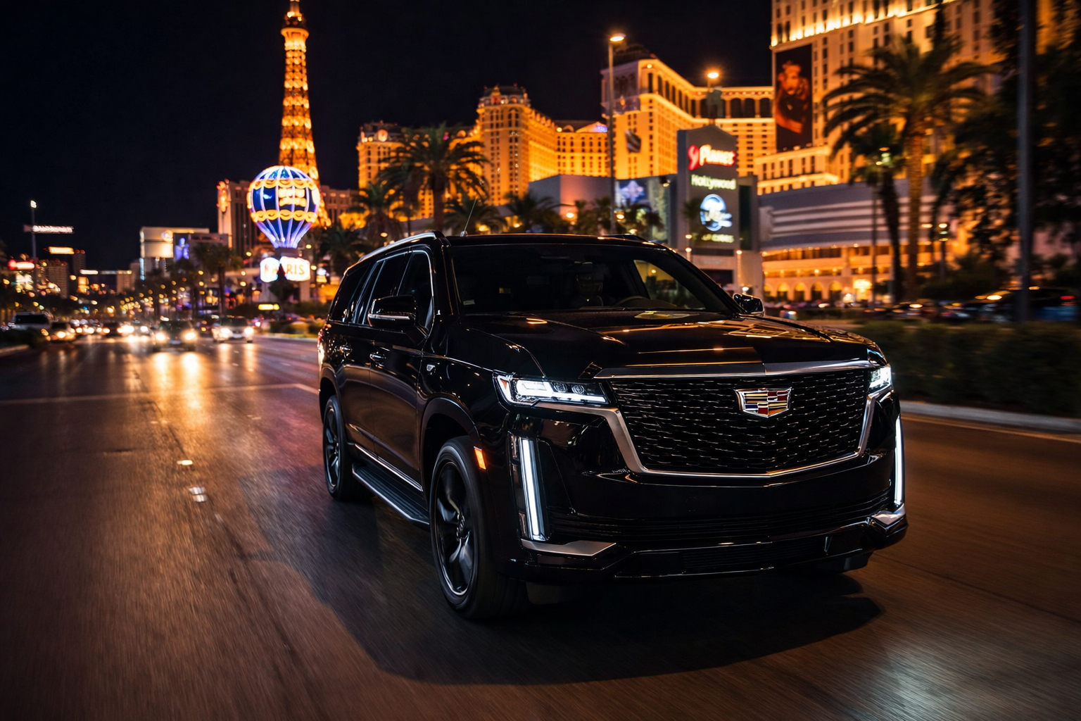 Cadillac Escalade luxury SUV driving in Las Vegas at night
