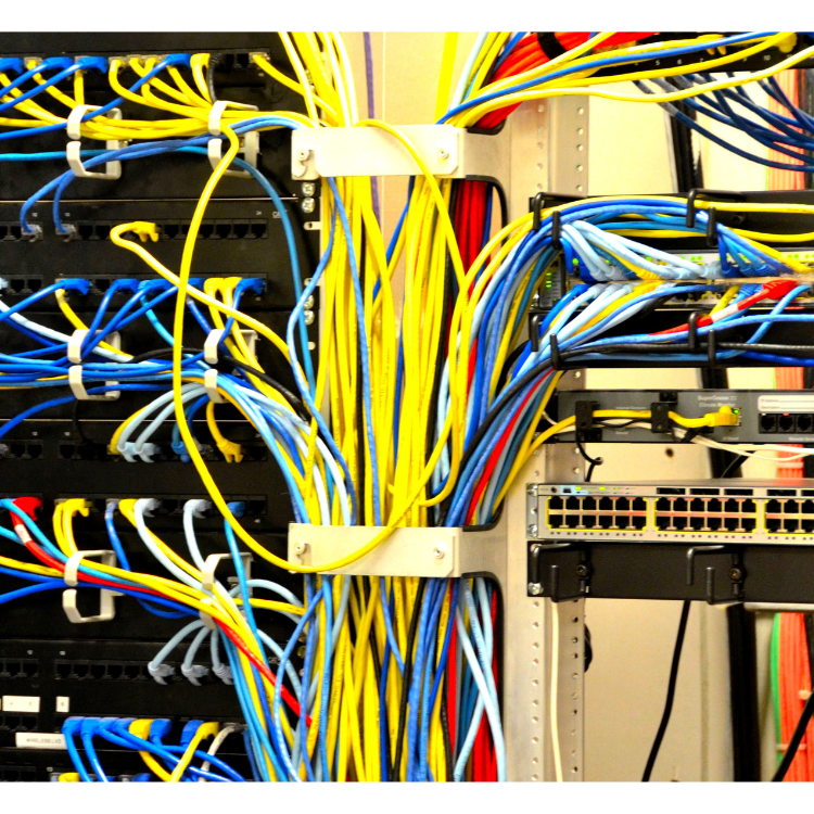 A bunch of wires are connected to each other in a server room.