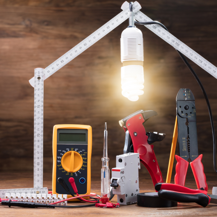 An electrician 's tools are arranged in the shape of a house