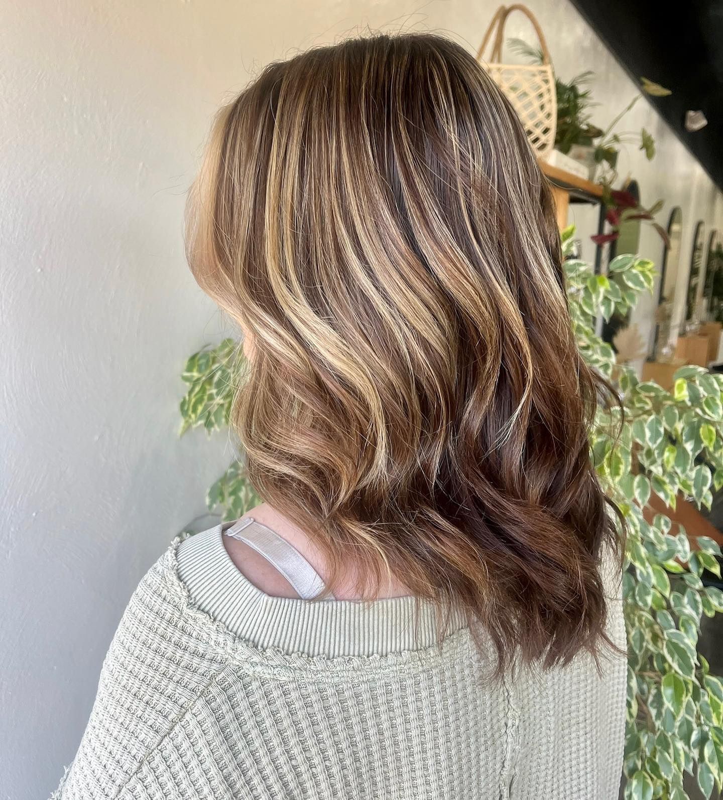Woman with wavy, highlighted brown hair.