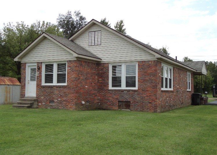 house with red bricks and green lawn