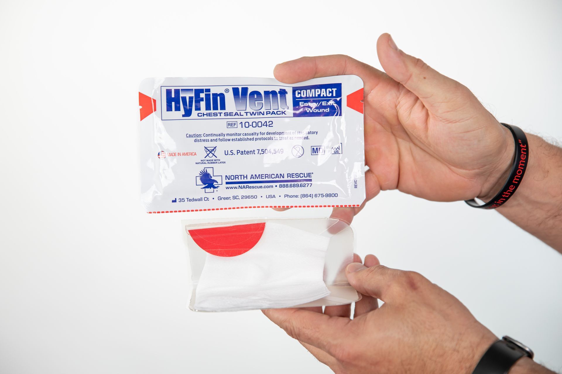 A person is holding a bag of hyfin wipes in their hands.