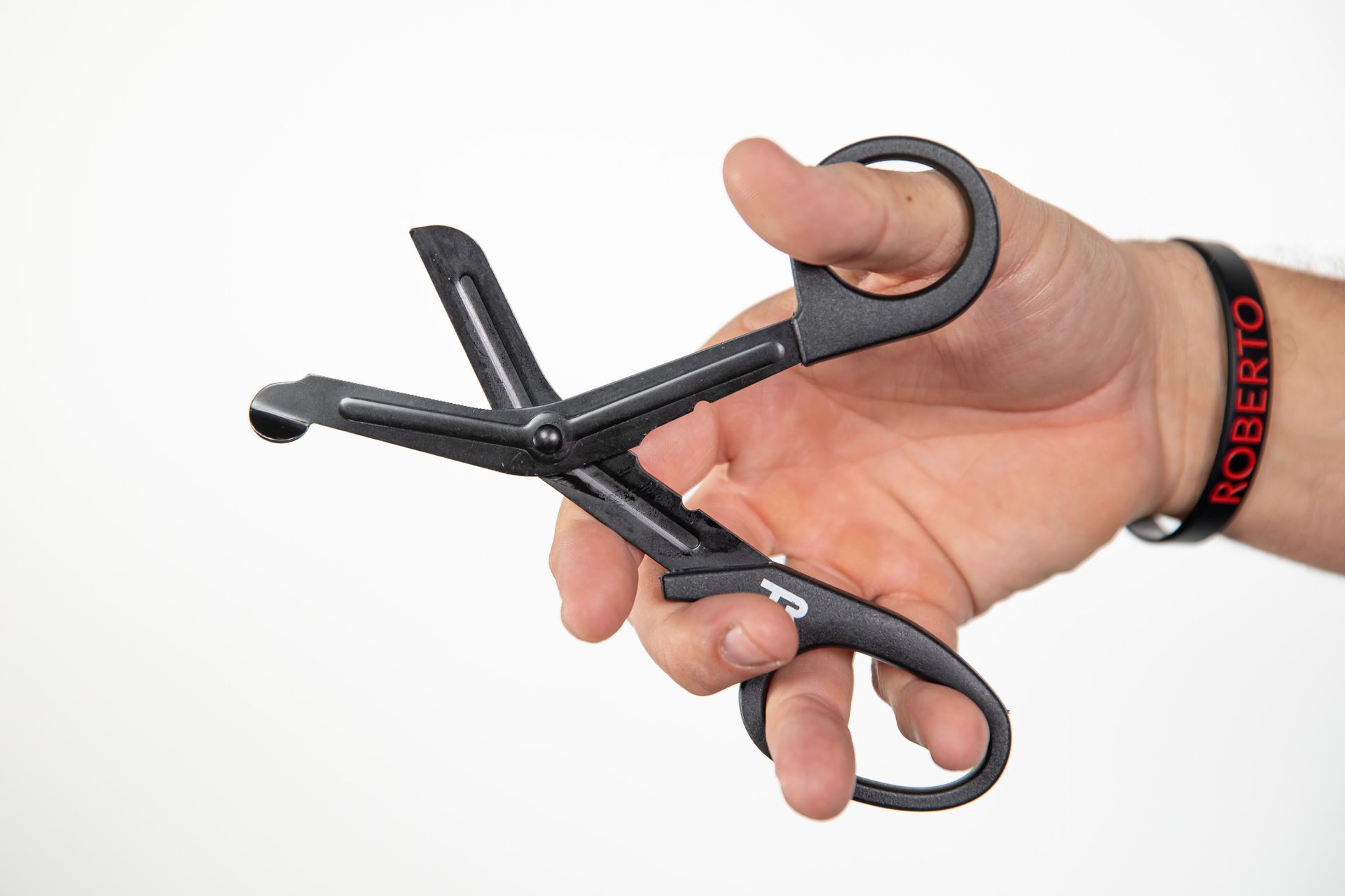 A person is holding a pair of scissors in their hand.