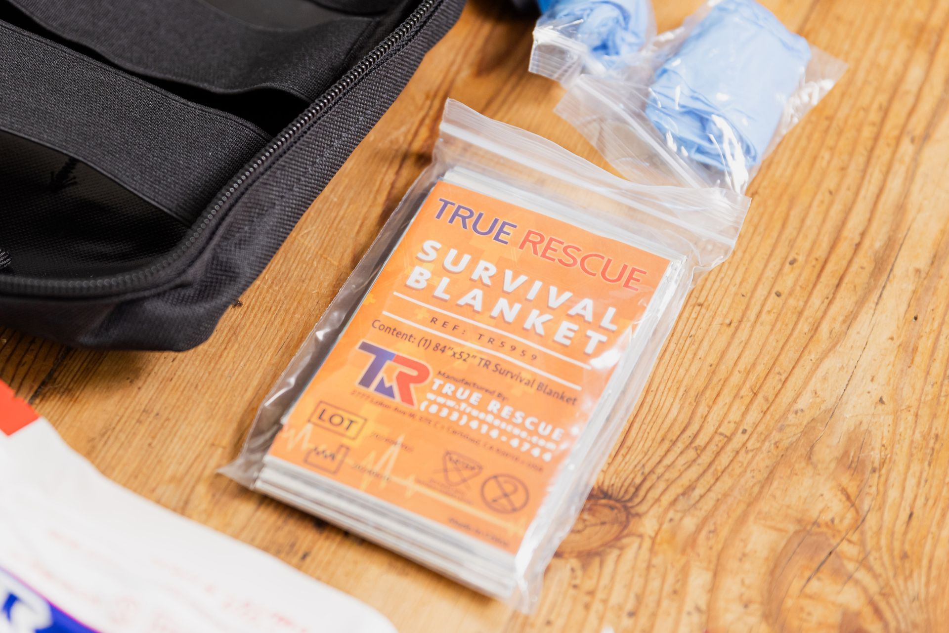 A person is holding a survival blanket in their hand.