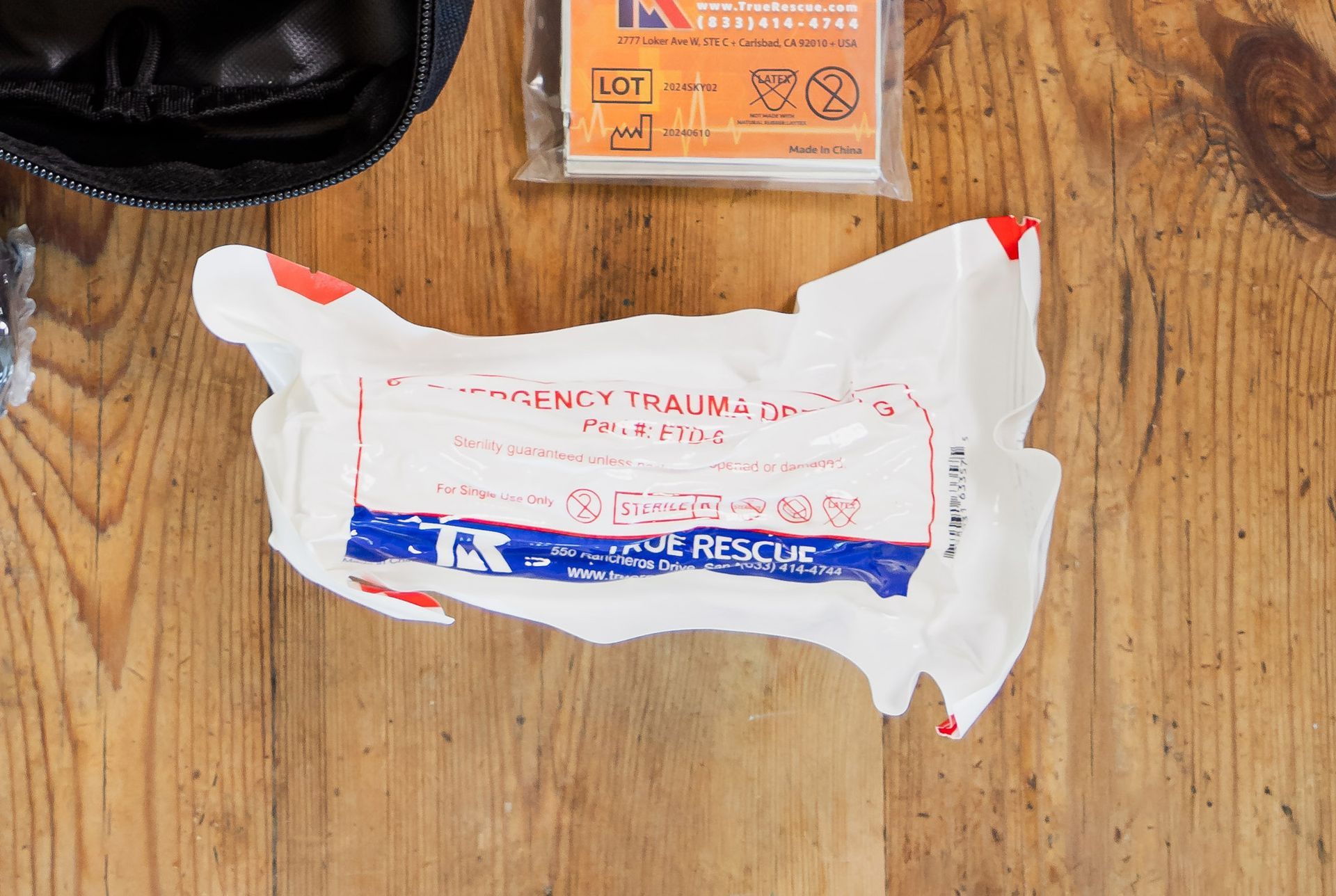 A first aid kit is sitting on a wooden table