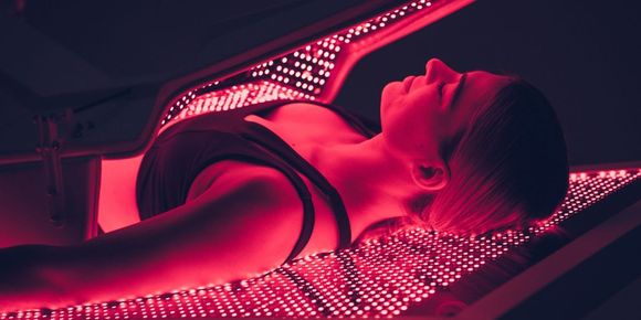 Pink towel and candlelit bathtub in a soft-focus spa setting