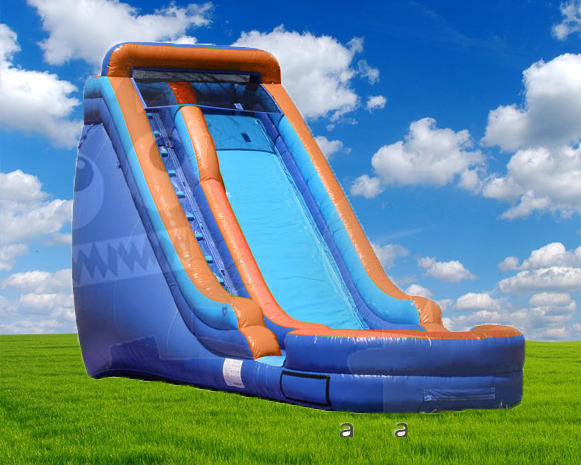 Blue and orange inflatable slide on a grassy field under a bright sky with clouds