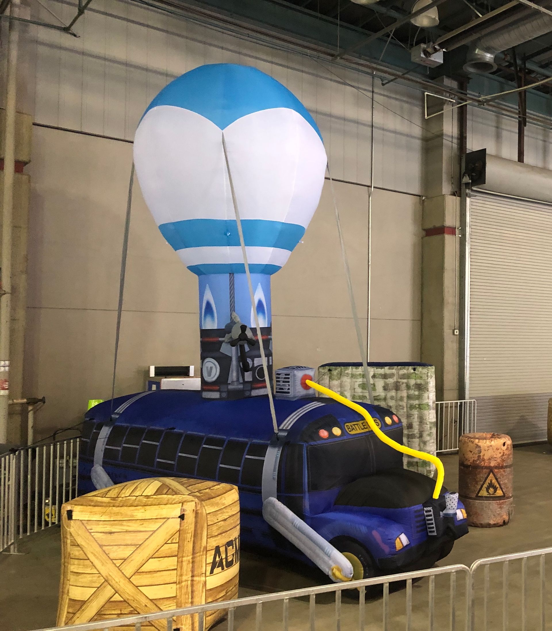 Blue-and-white hot air balloon basket in an indoor warehouse with crates nearby