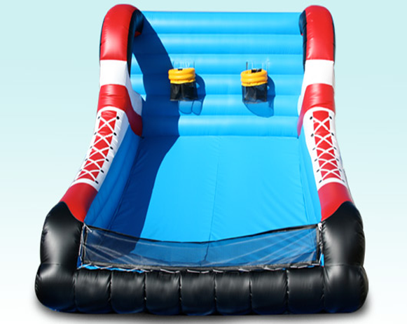 Blue and red inflatable slide with two yellow handles and black base, viewed from the front