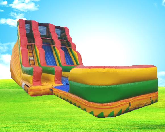 Colorful inflatable bounce house with slide on a grassy field under a blue sky
