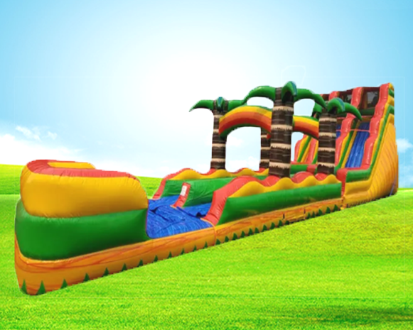 Colorful inflatable obstacle course with slides on a grassy field under a blue sky