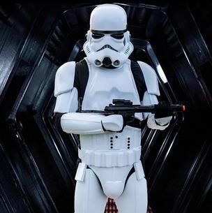 White Stormtrooper holding a blaster in a dark sci-fi corridor