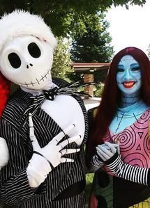 Jack Skellington and Sally Halloween costumes posing outdoors, holding hands and smiling.