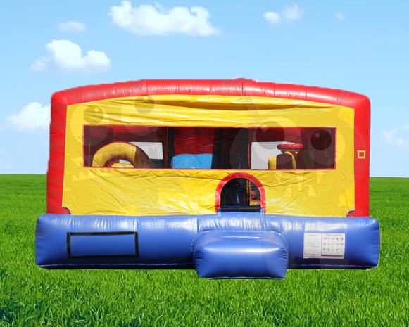 Colorful red, yellow, and blue inflatable bounce house on green grass under a blue sky.