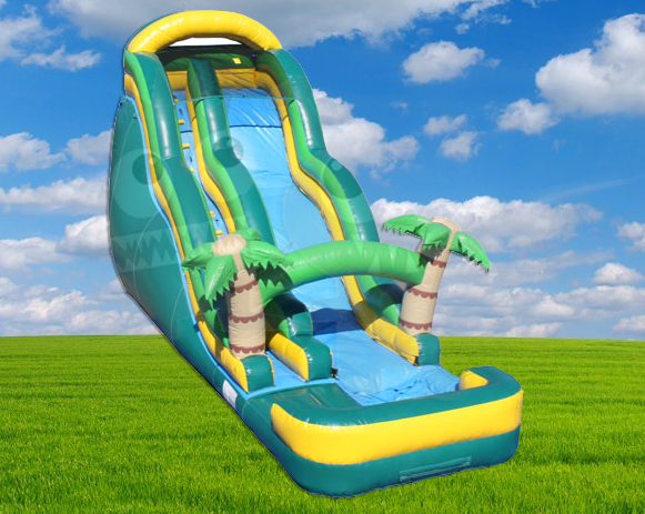 Bright green and yellow inflatable water slide with palm trees on a grassy field under a blue sky.