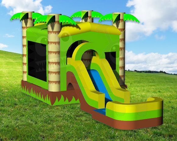 Bright green and yellow inflatable slide with palm trees on a grassy field under a blue sky