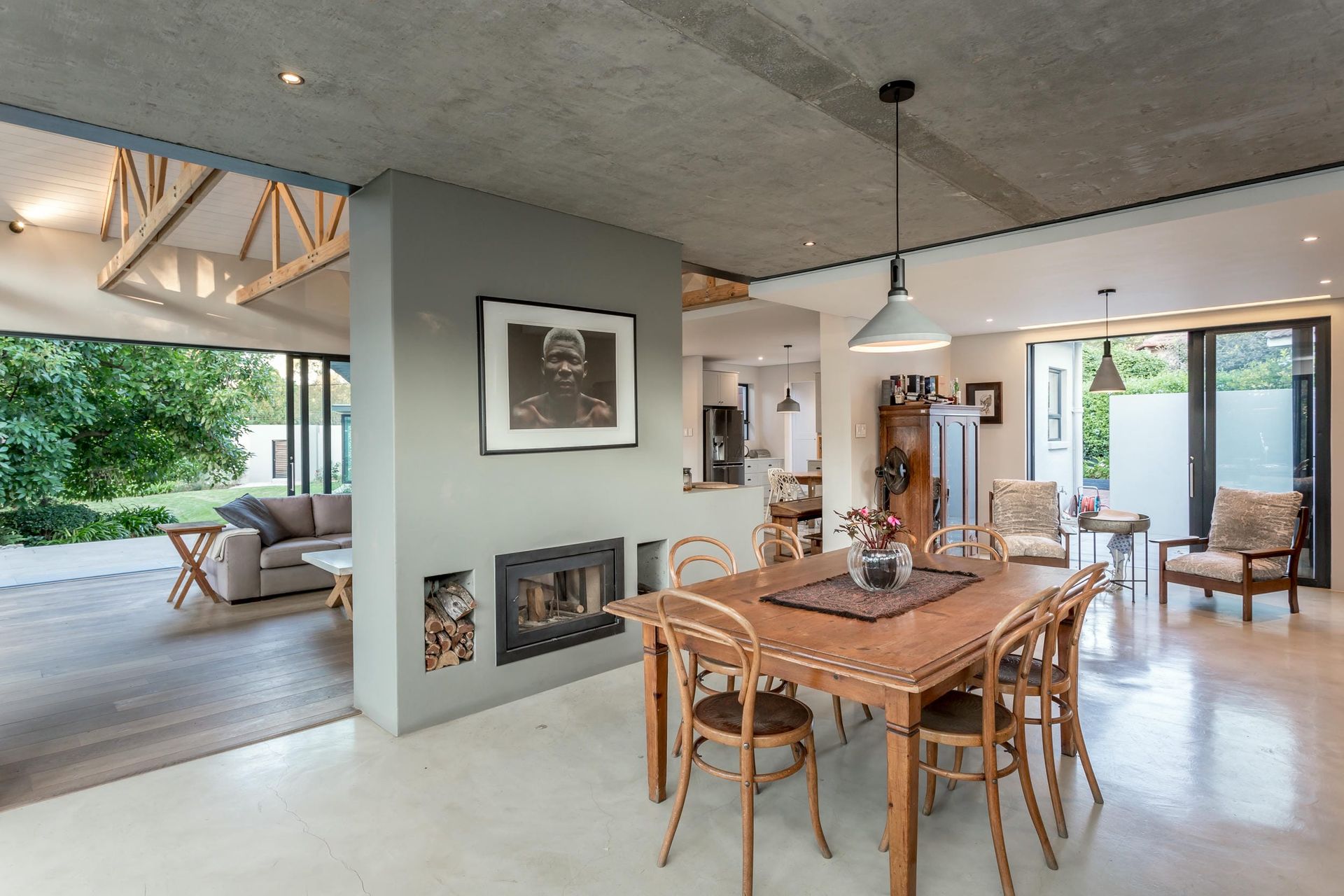 A dining room with a table and chairs and a fireplace.
