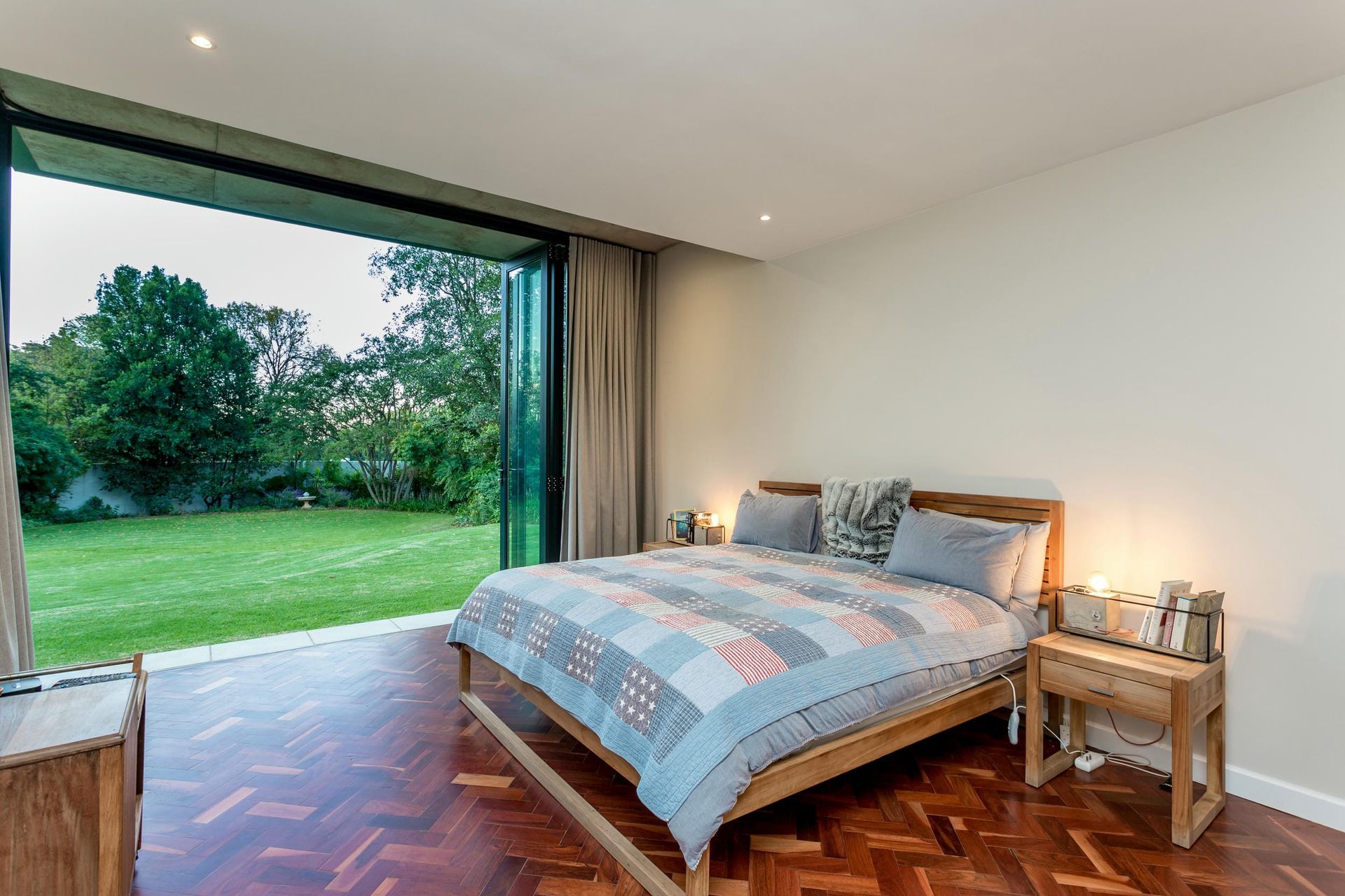 A bedroom with a large bed and a large window.
