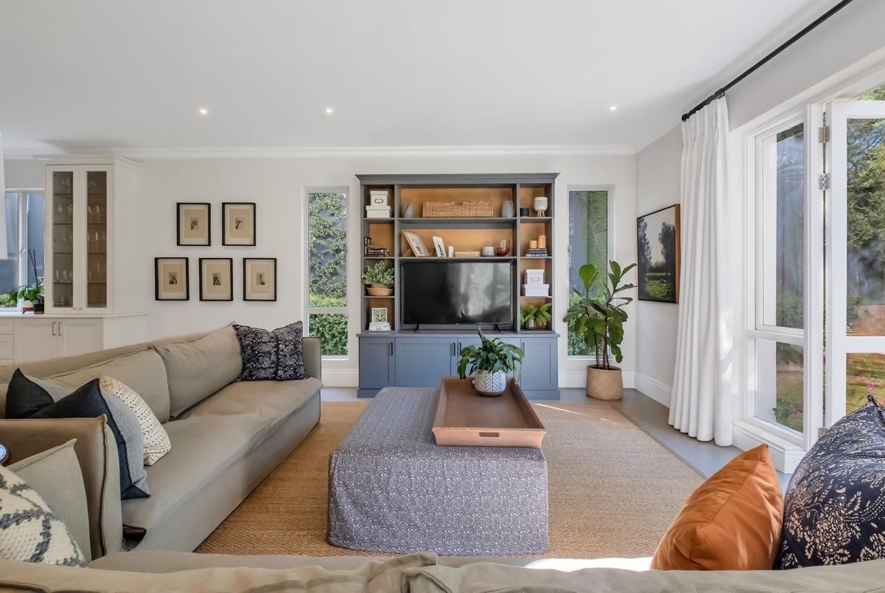 A living room with a couch , coffee table , and television.