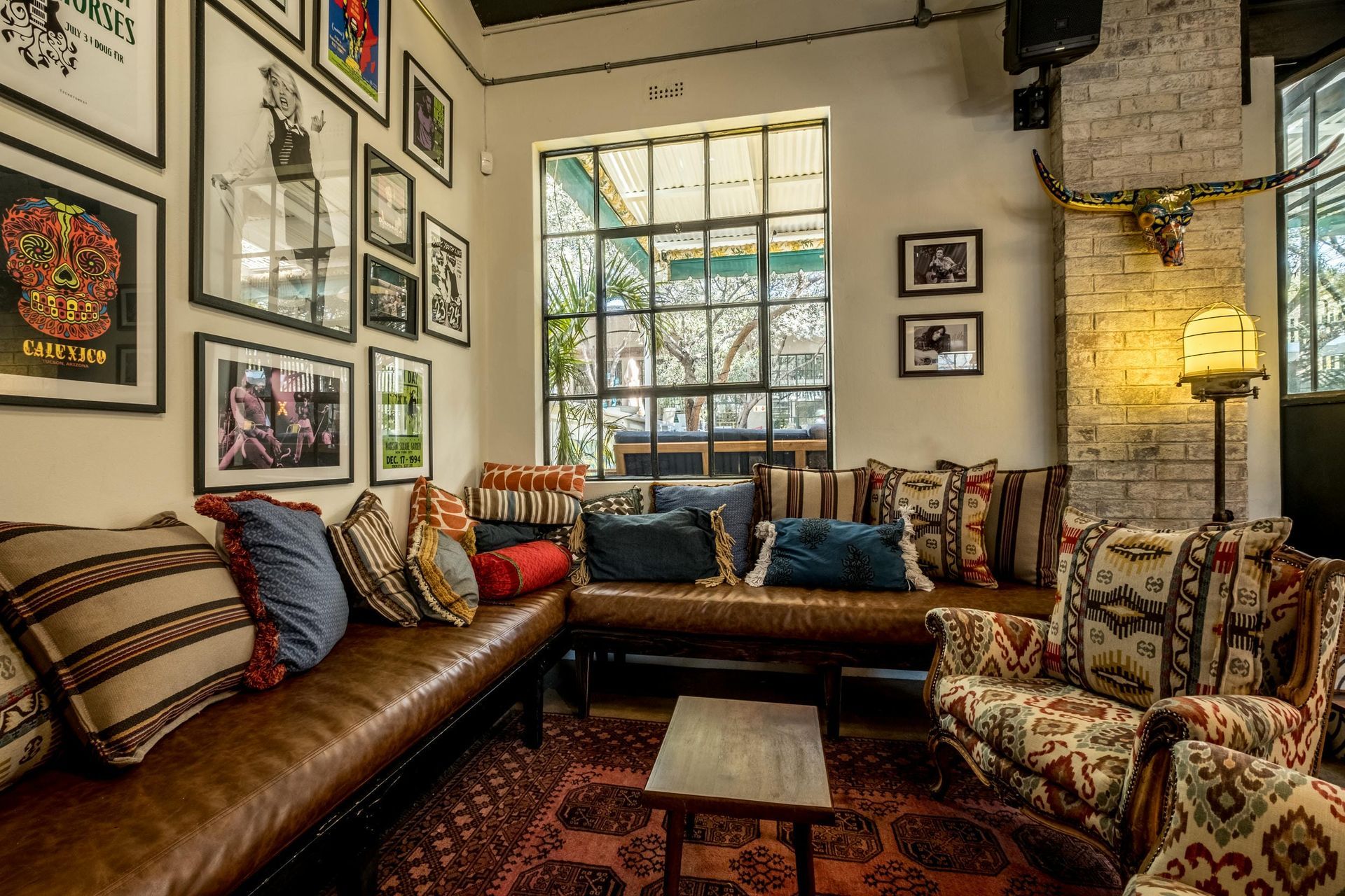 A living room with a couch , chairs , and a table.