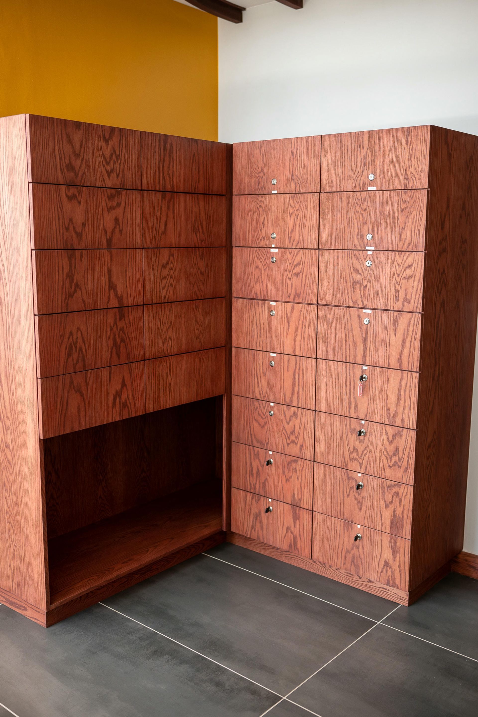 A corner of a room with a lot of drawers and shelves
