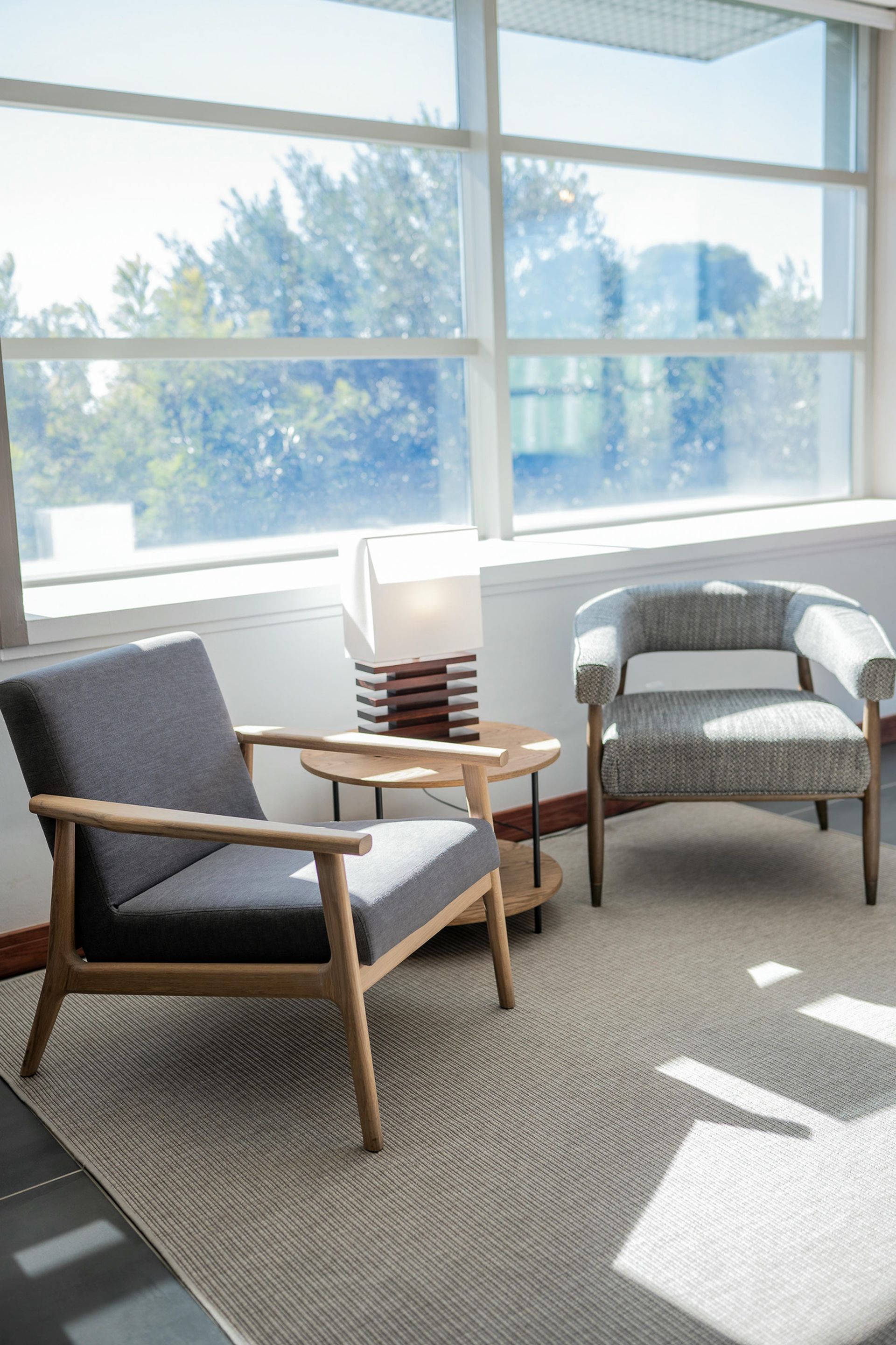 Two chairs are sitting in a room next to a window.