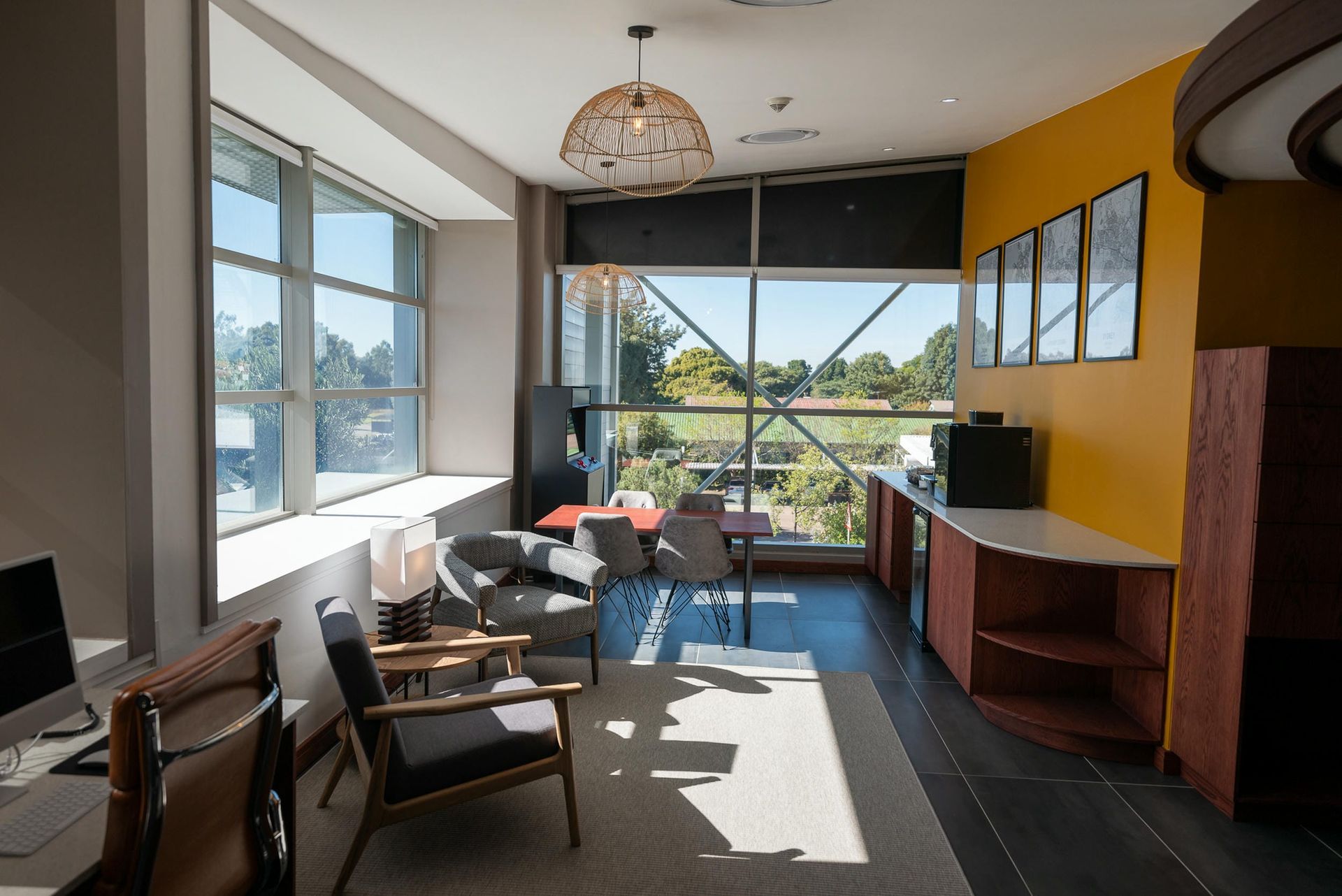 A living room with a lot of windows and chairs