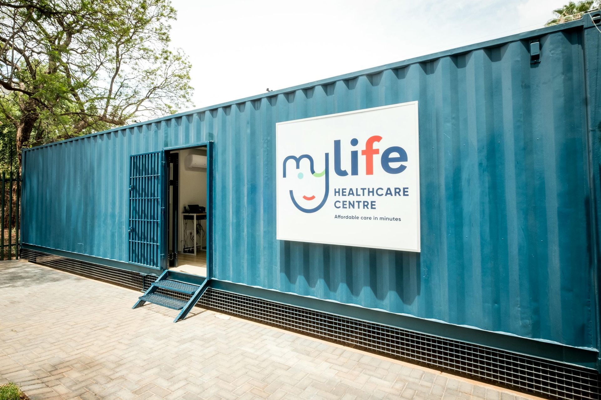 A blue shipping container with a sign on the side that says `` my life healthcare center ''.