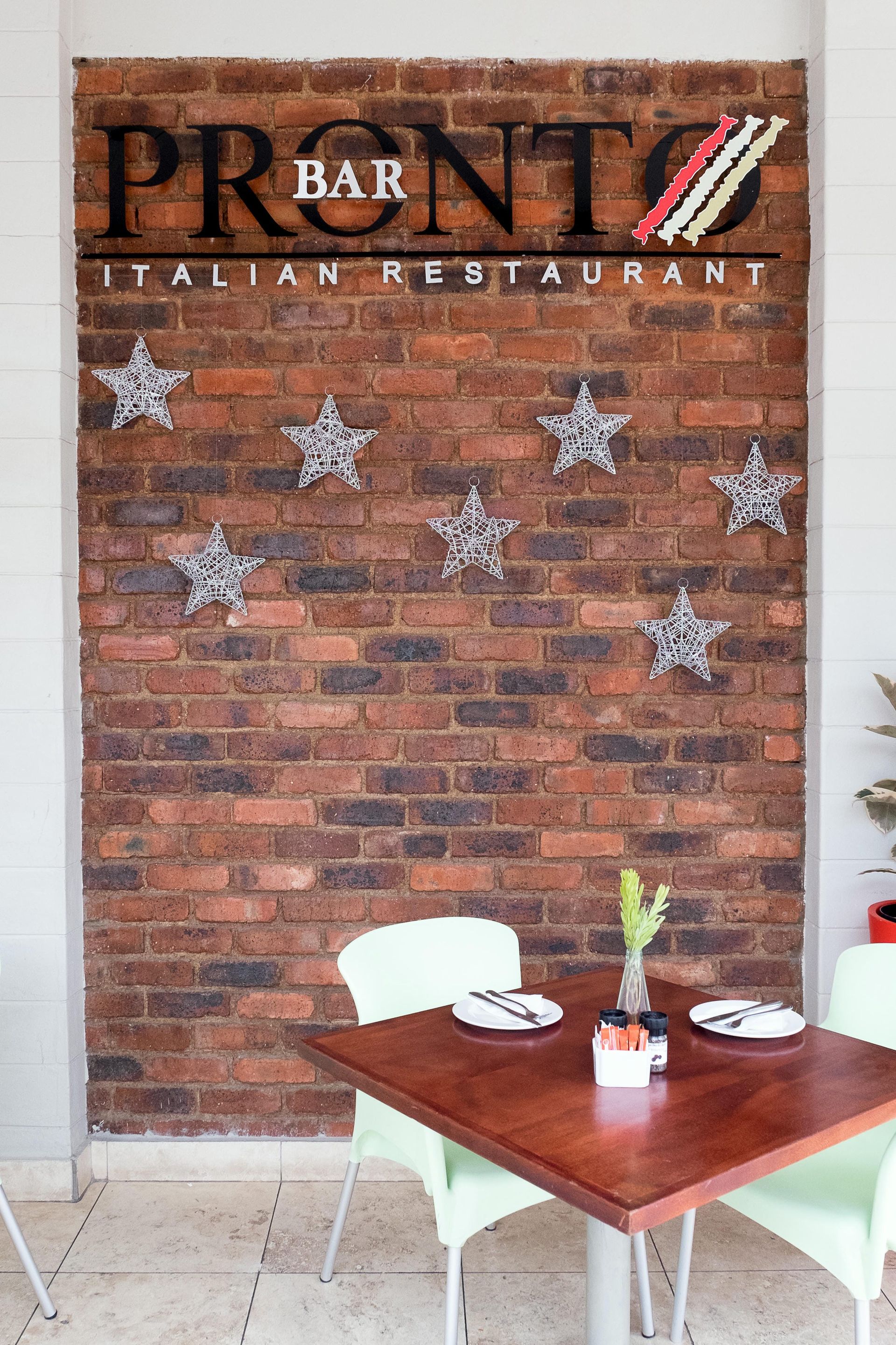 A brick wall with a sign that says pronto italian restaurant