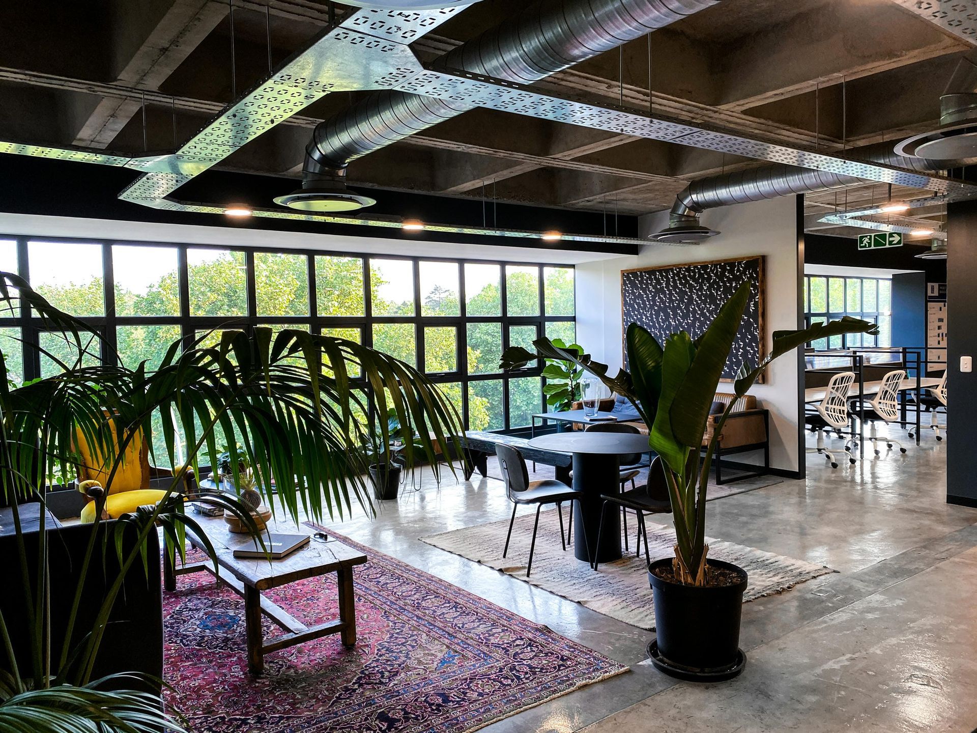 A large room with a lot of windows and tables and chairs.