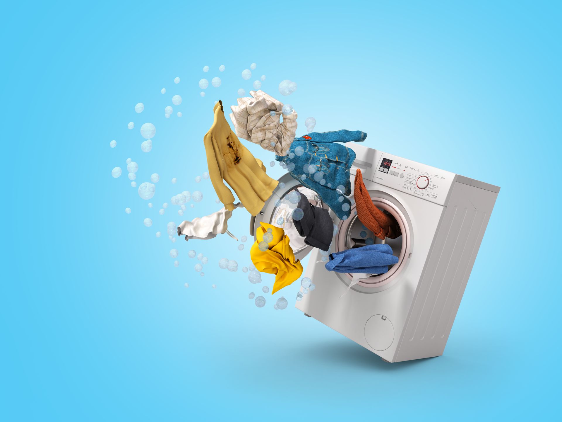 Clothes flying out of a washing machine on a blue background. Clothes flying out of a washing machine on a blue background.