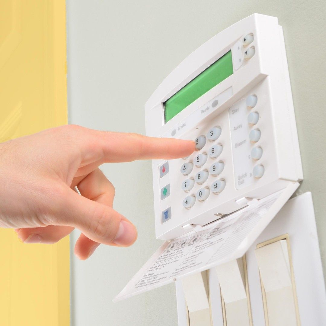A Person is Pressing a Button on a Security System — SPL Security Solutions In Bundall, QLD