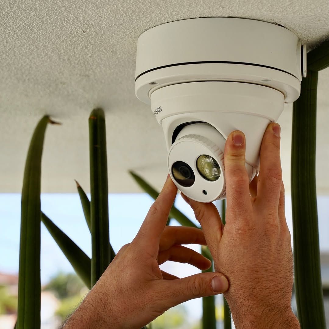 A Person is Installing a Security Camera on the Ceiling — SPL Security Solutions In Southport, QLD