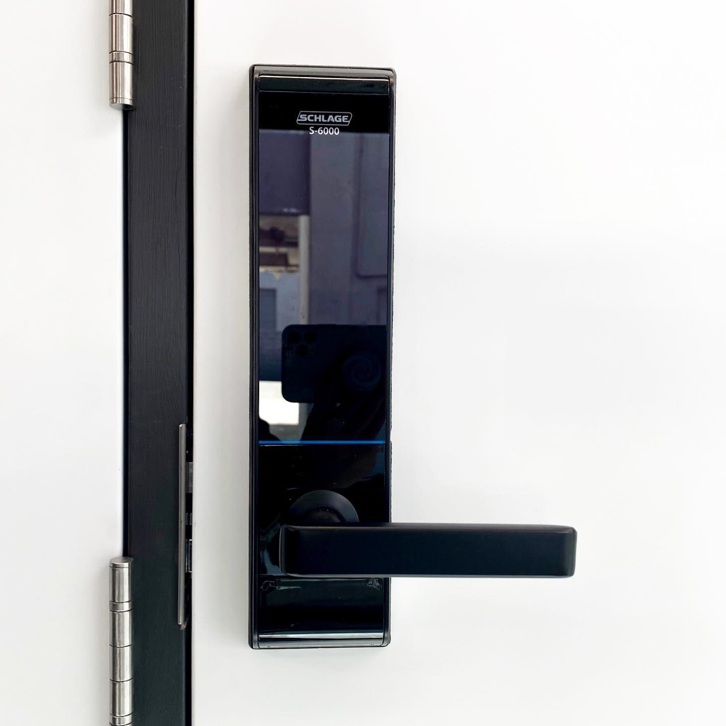 A Black Door Lock is Sitting on a White Door — SPL Security Solutions In Main Beach, QLD