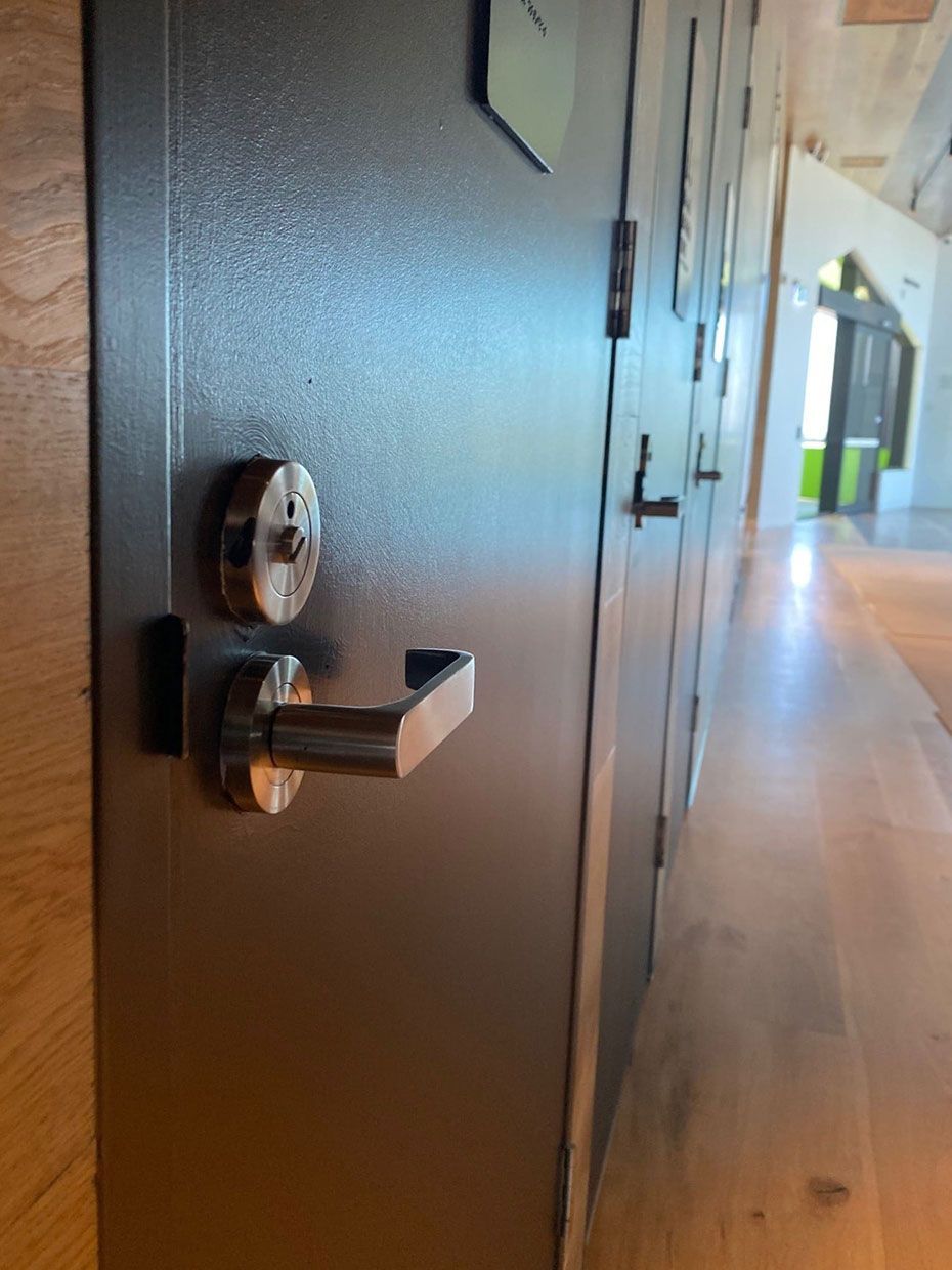 A Door With a Key on It in a Hallway — SPL Security Solutions In Currumbin, QLD