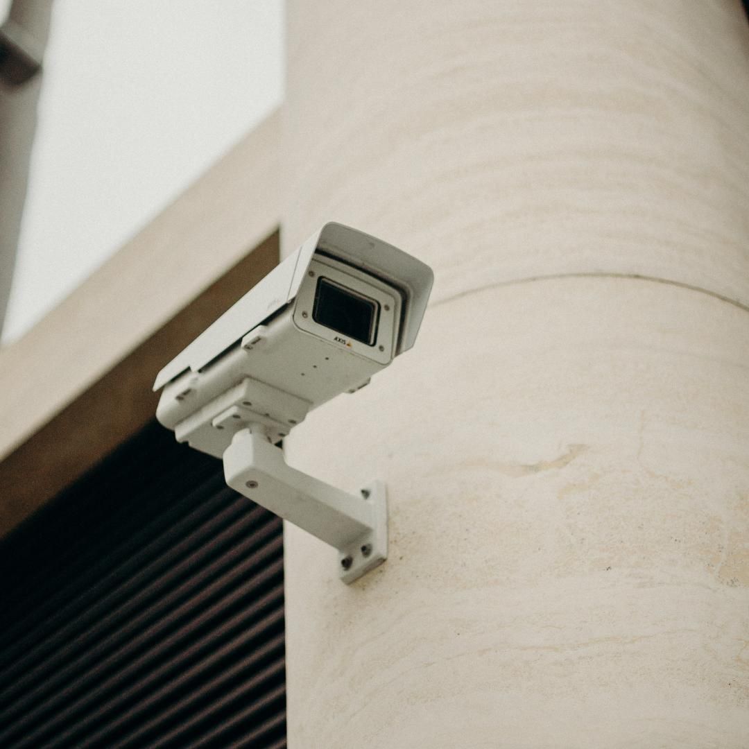 A Security Camera is Mounted on the Side of a Building — SPL Security Solutions In Southport, QLD