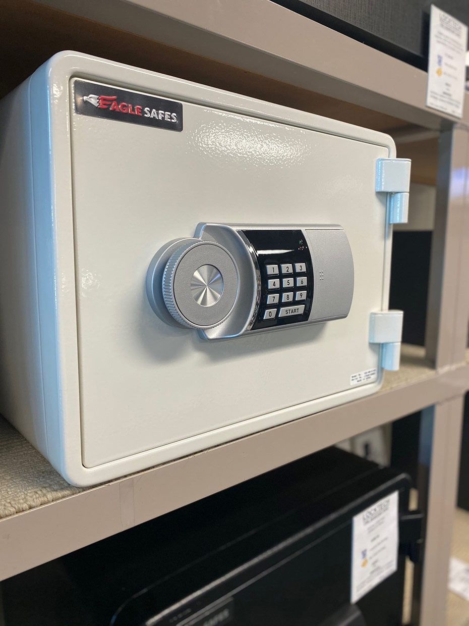 A White Safe is Sitting on Top of a Shelf — SPL Security Solutions In Tweed Heads, NSW