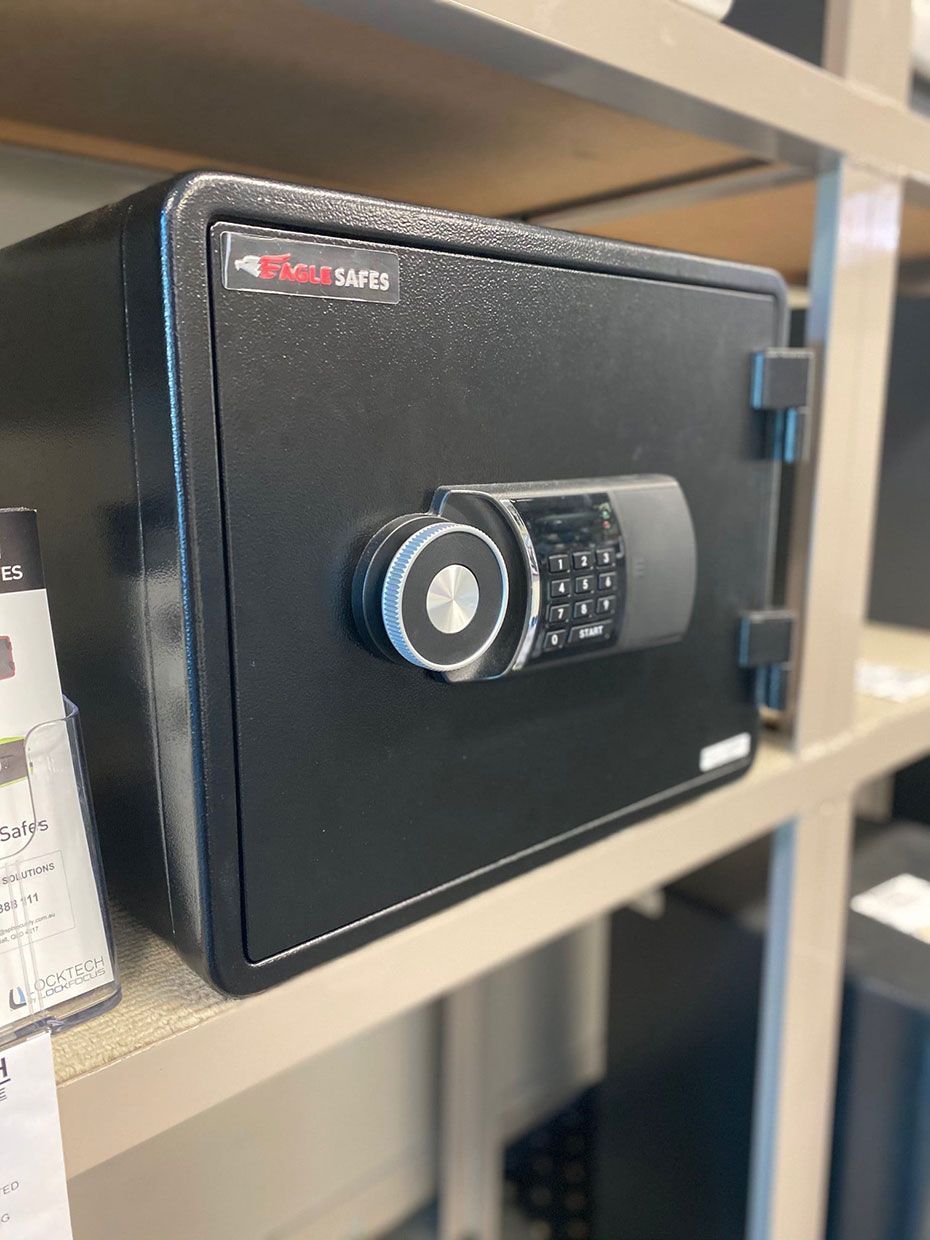 A Black Safe is Sitting on Top of a Shelf in a Store — SPL Security Solutions In Tweed Heads, NSW