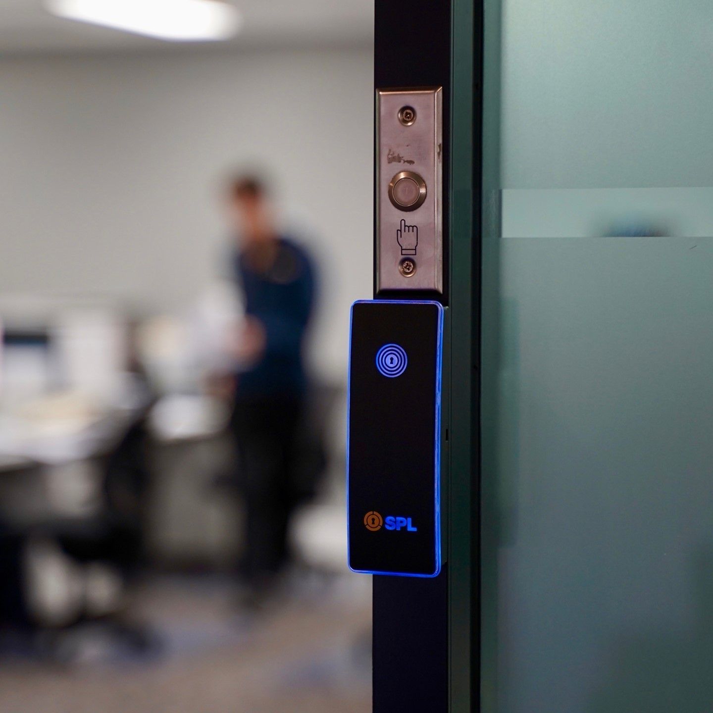 A Blurry Picture of a Man Standing Behind a Glass Door — SPL Security Solutions In Gold Coast, QLD